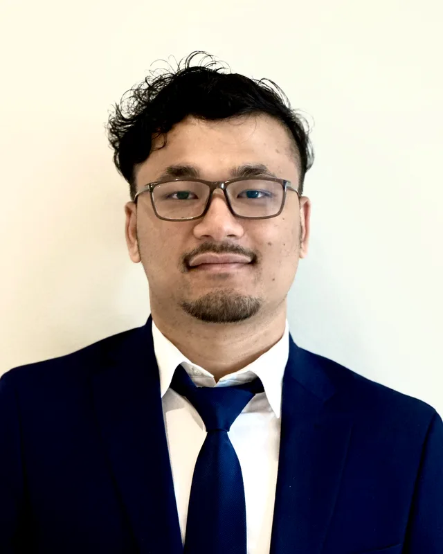 Portrait of Bickey Manandhar in a navy suit